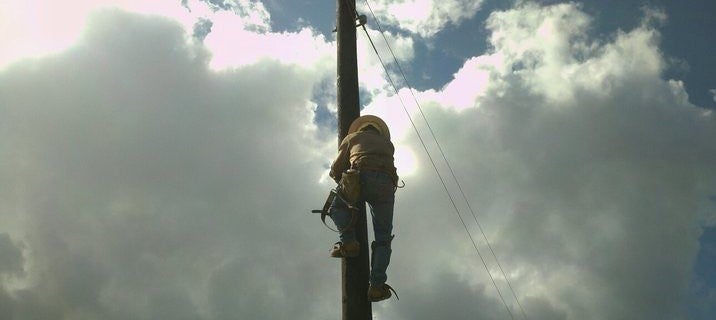 Lineman climbing pole